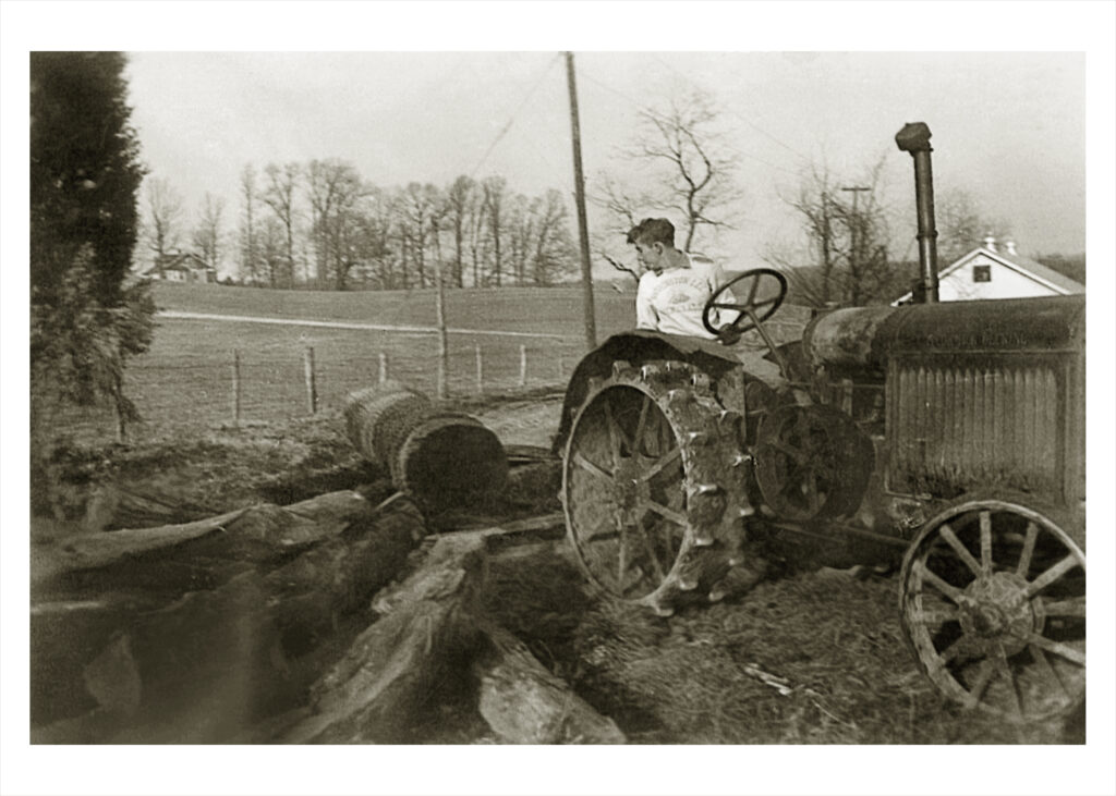Photo of George Reed moving logs in 1949 on the Reeves farm.