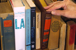 hand taking books of a shelf