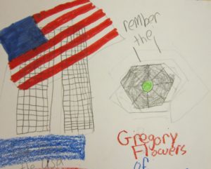 a child's drawing of two tall buildings, the American flag and the Pentagon.