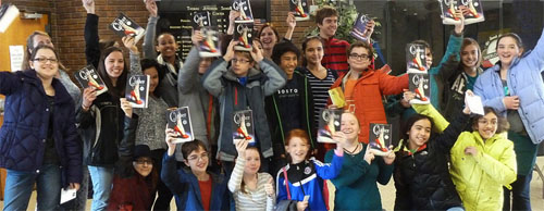 Photo of students at an All TAB event, holding Melissa Meyer's book up