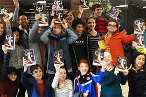 kids holding "Cinder" book