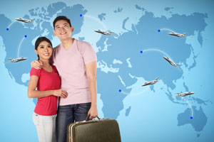Couple standing in front of a world map