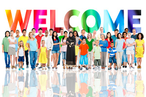 The words welcome in a rainbow colored font above an group of diverse human beings