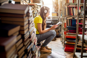 Young woman surrounded by books