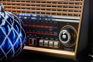 radio receiver in retro style with christmas decorations on black background