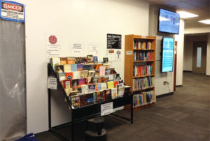 Wire rack display of books next to construction entrance 