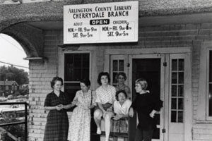 Photo of female librarians standing in front of old Cherrydale library building