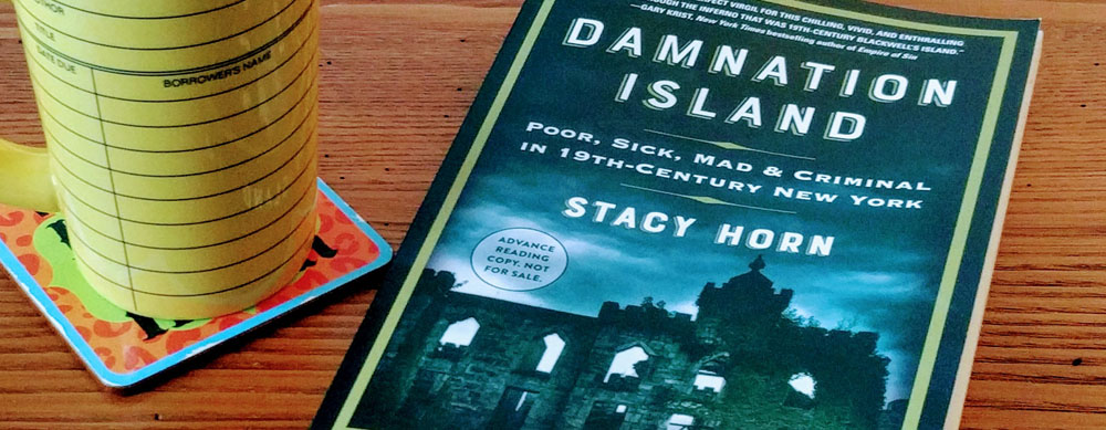 photo of the book "Damnation Island" next to a cup of coffee