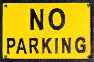 No Parking sign, black letters on yellow background