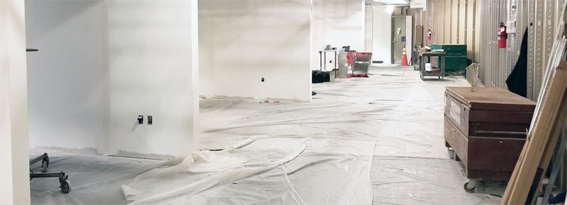 White walls and a construction box with tarp on the floor