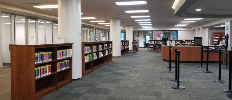 Photo of new Central Library circulation layout with New Books shelves on the left between circulation desk and Meeting rooms