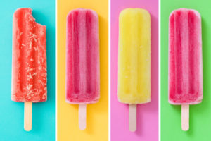 four popsicles on a blue background