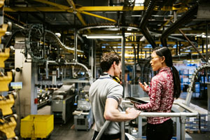 photo of Mechanic and Engineer Talking in Factory