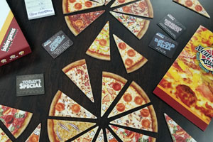 New York Slice tabletop game has pieces shaped like slices of pizza