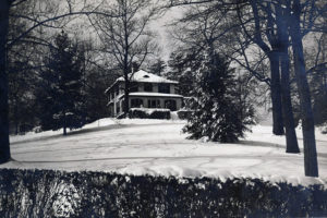 Dudley Family Home, 1920s black and white photo, taken on a hill covered in snow