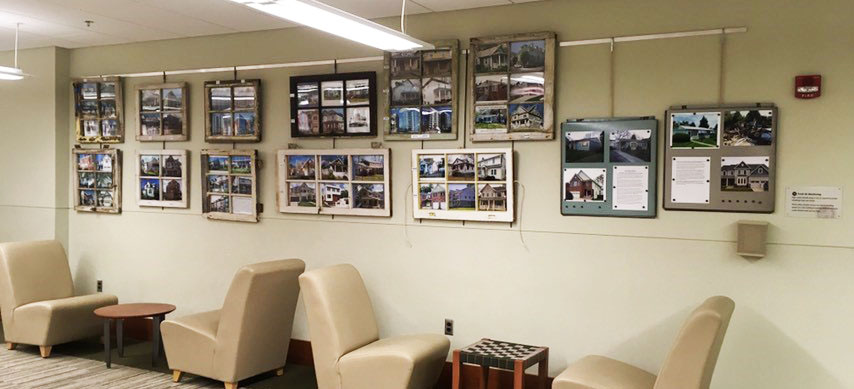 Window frame filled with photos of buildings before and after remodeling