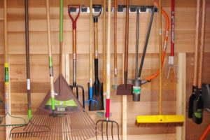garden tools hanging in the shed