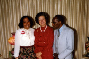 Edmund Fleet and an unknown woman flank Lady Bird Johnson at a Chuck Robb campaign event held at Fleet's house