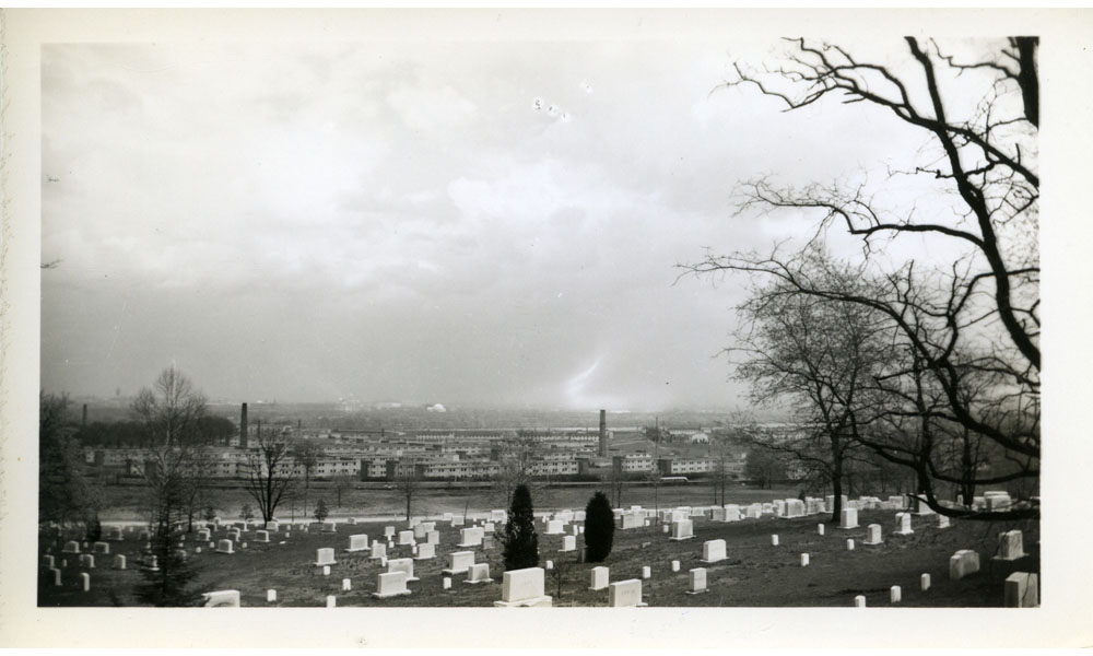 A view of Arlington Farms from Arlington National Cemetery, Washington, D.C. is visible in the background.