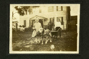 Two children and a dog cart, date unknown, after 1912