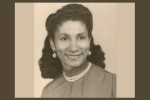 photo of Dorothy Ham, a beautiful black woman wearing pearl earings and a necklace, smiling at the camera