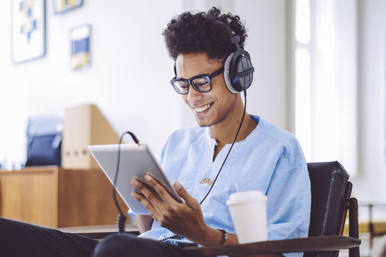 Man listening to an audiobook on tablet