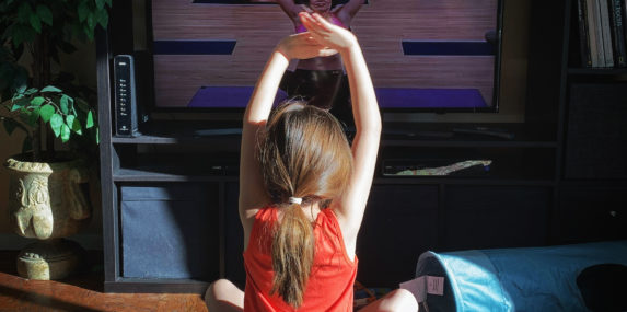Eva Boal, 8, finishes her yoga workout at home on her first day of "spring break", while quarantined during the COVID-19 pandemic on Monday, April 6, 2020. Schools were closed for the year several weeks ago, and since then, her school has been scheduling daily video calls with her teacher and classmates. Monday was the first day of Spring Break where there were no video calls and classwork, so she decided to try a yoga session in the living room.