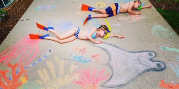 Each day my twin brother Sully and I do a chalk drawing about something we miss or are longing for during quarantine and incorporate ourselves into it. We were supposed to go snorkeling in Hawaii over Spring Break, so we created a fun underwater image of us snorkeling with fish and other sea creatures. We've also created images of our summer swim and dive teams, fishing and crabbing, watching the sunset on the beach, soccer games and dance recitals and even playing on the playground with our friends!