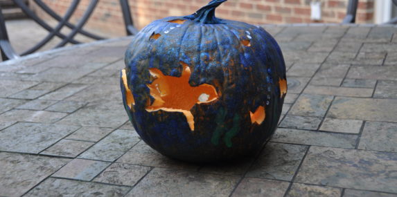 I carved different sea creatures all around the pumpkin and then painted an ocean scene on it.