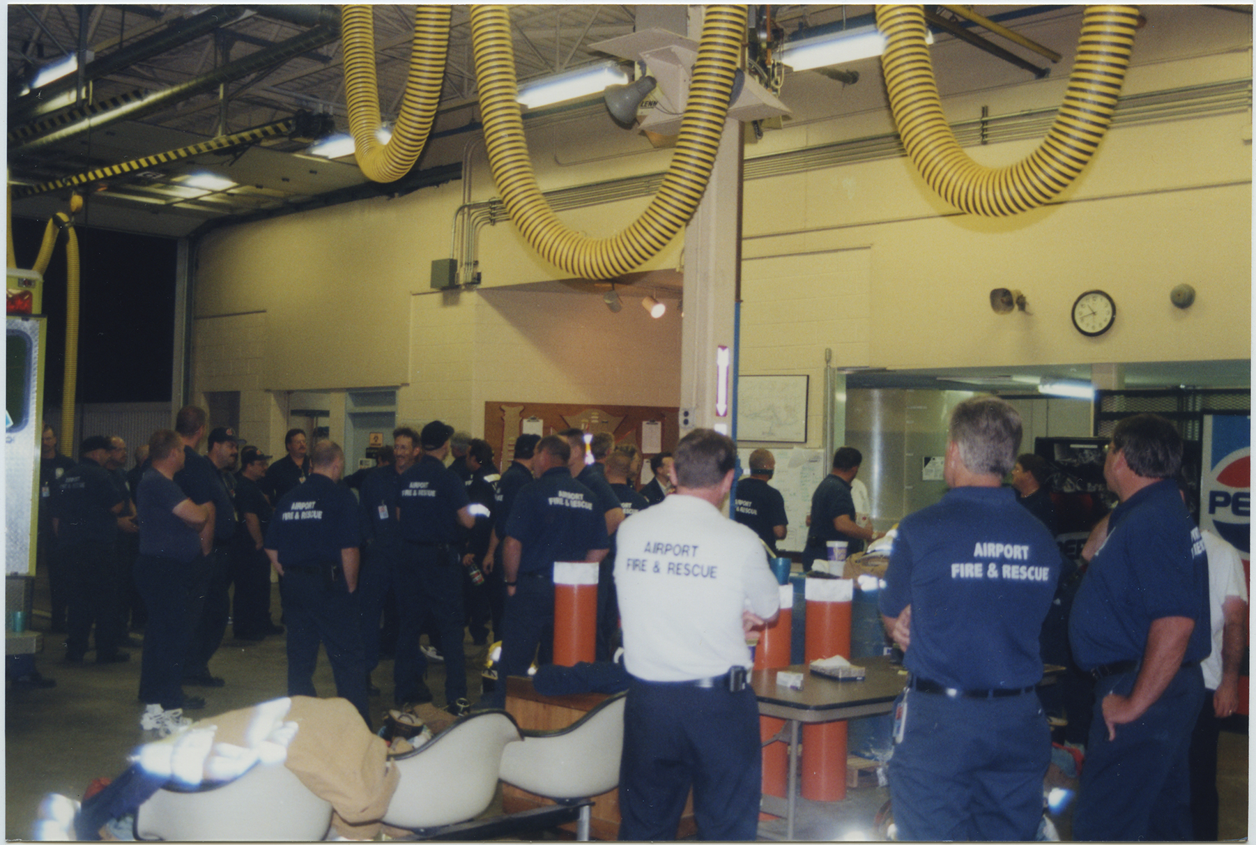 Fire fighters taking a much needed break at the National Airport fire station at 10pm on September 11, after a day long rescue effort at the Pentagon following the attacks. 2001, 1 print, col., 4 x 6 in..