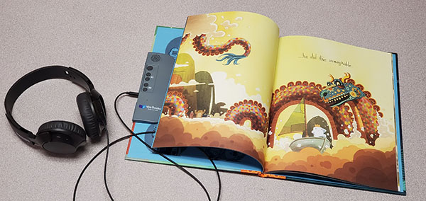 photo of a VOX book shows the audio controls on the inside cover of the book.