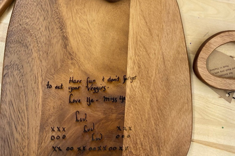 Photo of an engraved cheese wood cutting board.