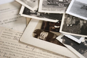 scattered family photos on top of historic document.