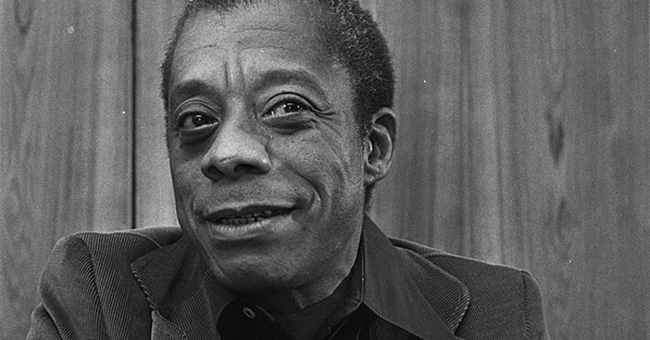 A black and white photo of James Baldwin.