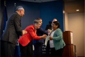 Library Director Diane Kresh and Arlington County Board Chair Takis Karantonis greeting a new citizen of the United States of America.