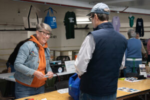 Library Director Diane Kresh talking to a FOAL book sale customer.