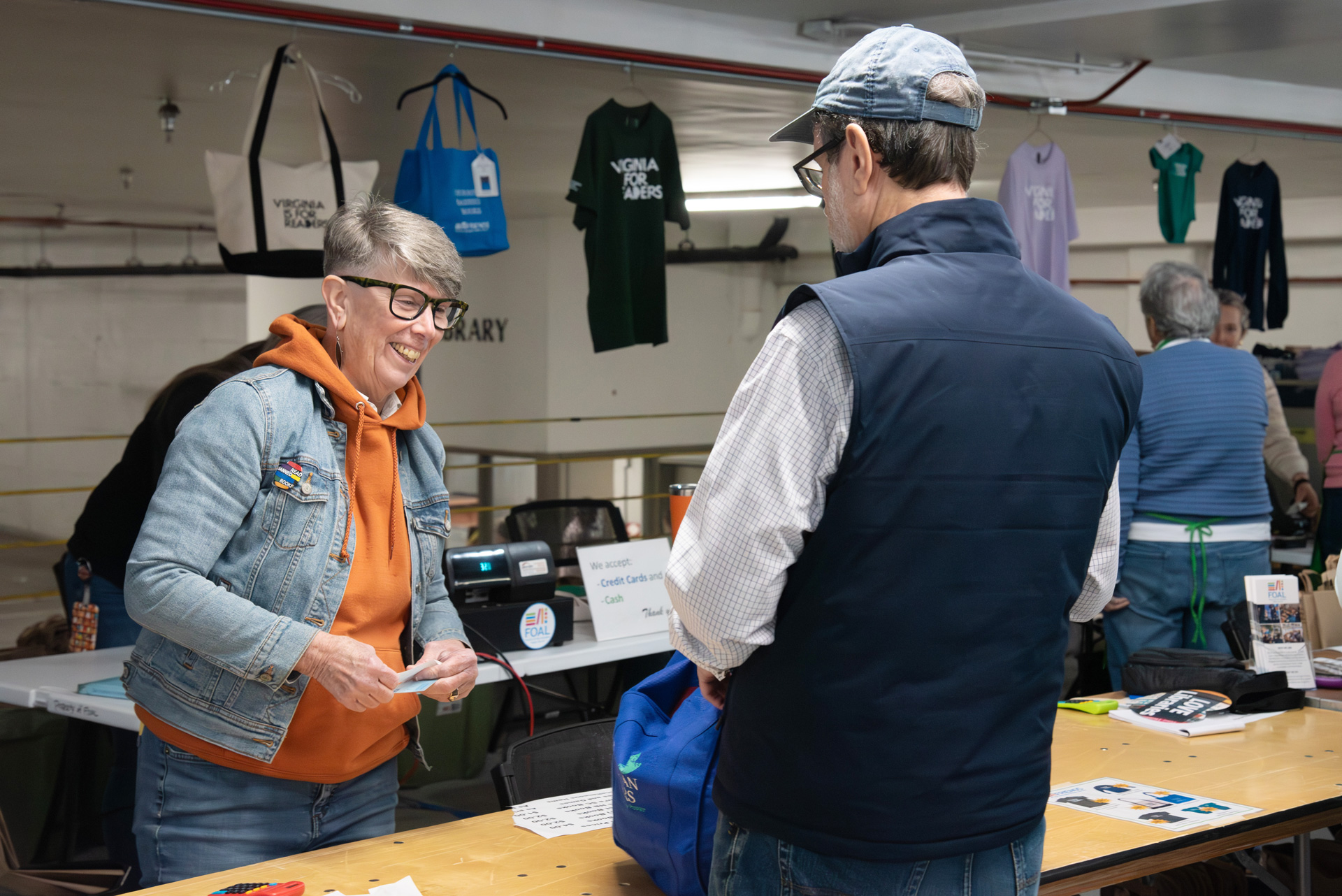 Library Director Diane Kresh talking to a FOAL book sale customer.