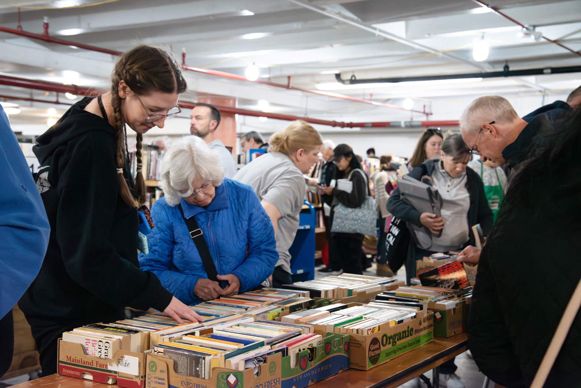 FOAL book sale shoppers browsing the used books collection.