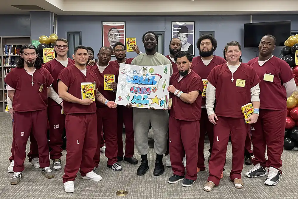 Nana Kwame Adjei-Brenyah poses with Community Readiness Unit book club members at the Arlington County Detention Facility.