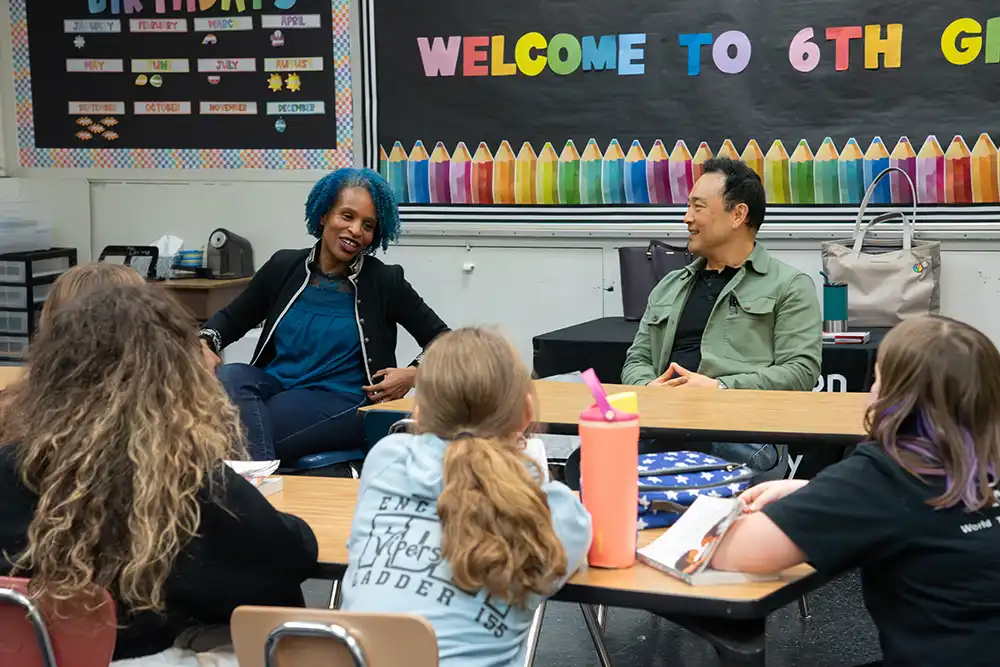 Authors David and Nicola Yoon speak to middle school students during a classroom Q&A.