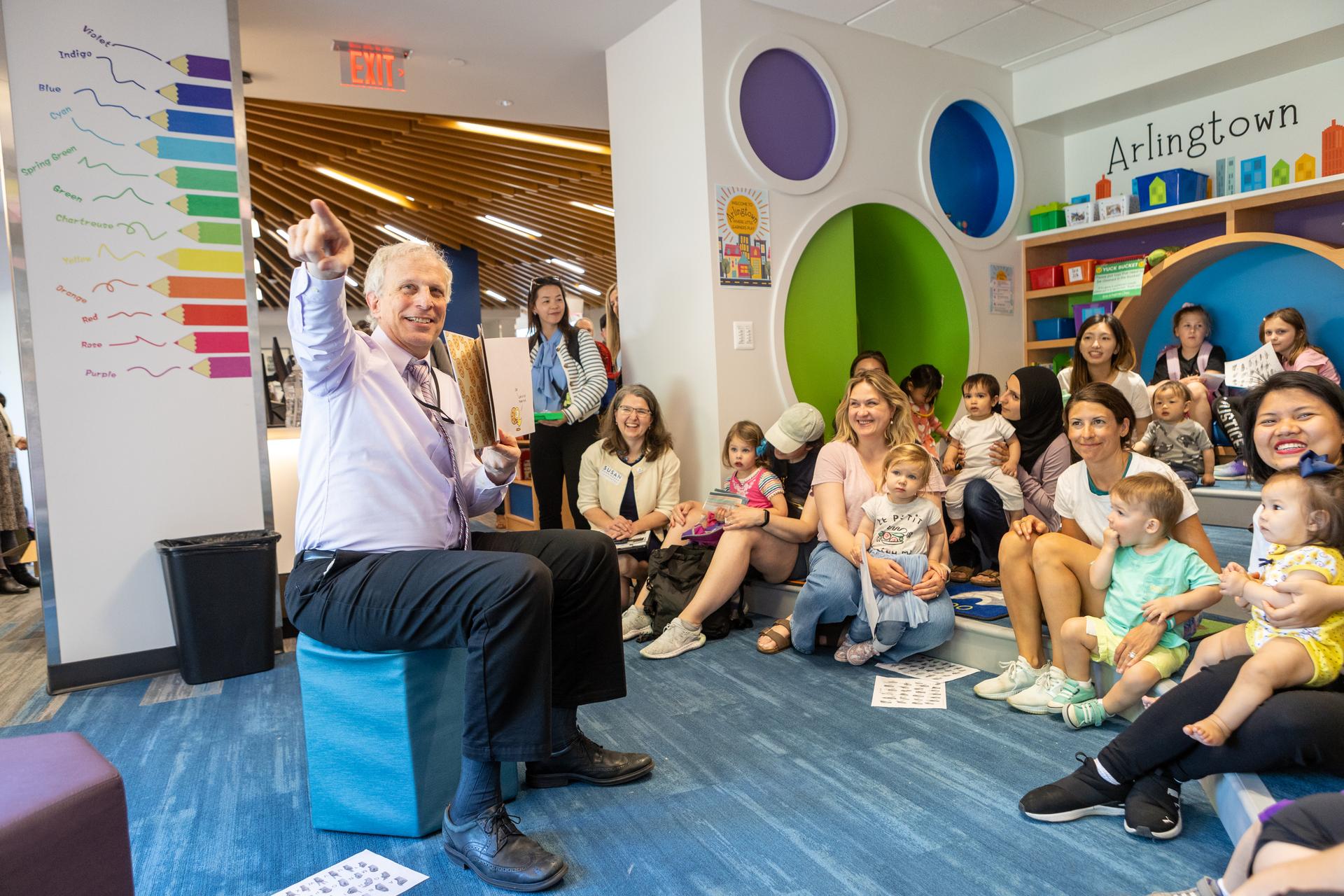 County Manager Mark Schwartz leads a storytime for young children.