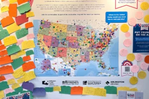 A poster of a United States map with stickers marking locations and memories at libraries across the country.
