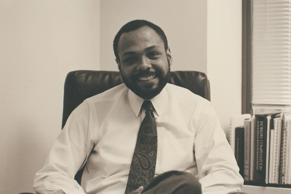 Charles Monroe sitting in an office chair.