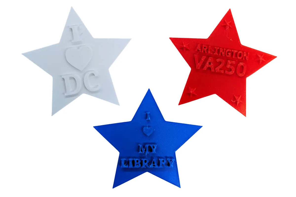 White, blue, and red 3D printed stars with text reading "I heart DC," "I heart my library," and "Arlington VA 250"