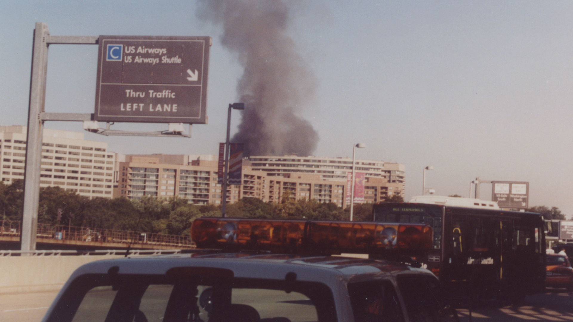 The plume of smoke from the Pentagon attack on September 11, 2001, taken as Michael Defina was en route from Ronald Reagan Washington National Airport. Photo credit Michael Defina. Charlie Clark Center for Local History, 133-01-01-02-0080