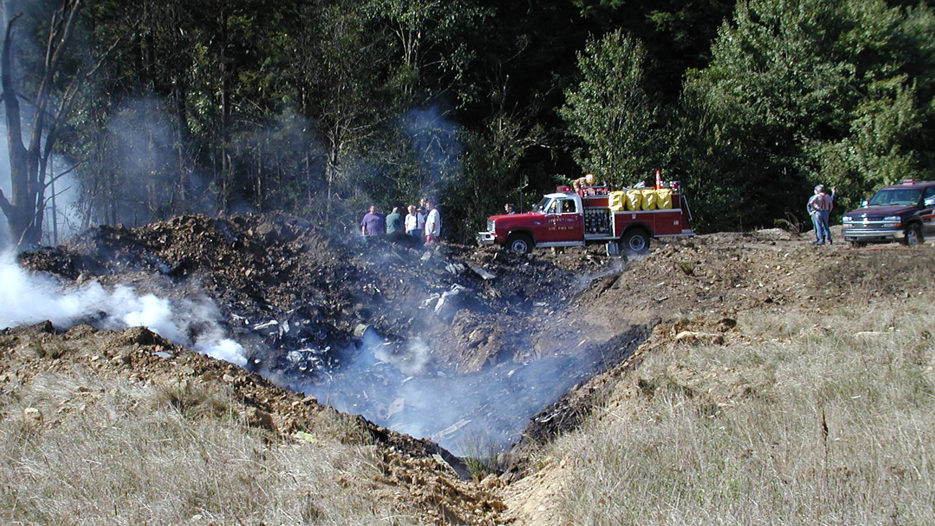 A firetruck and people at the crash site of United Airlines Flight 93, at a field near Shanksville, PA, after it was hijacked on September 11, 2001. Photo credit Mark Stahl. Library of Congress, Prints & Photographs Division, LC-DIG-ppbd-00038 