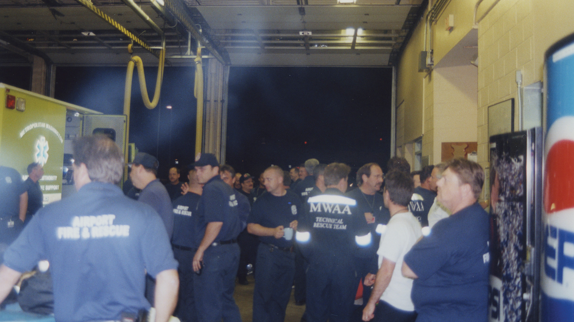 Firefighters taking a much-needed break at the Ronald Reagan Washington National Airport fire station at 10 p.m. on September 11, after a day-long rescue effort at the Pentagon following the attacks. Photo credit Michael Defina. Charlie Clark Center for Local History, 133-01-01-01-0033