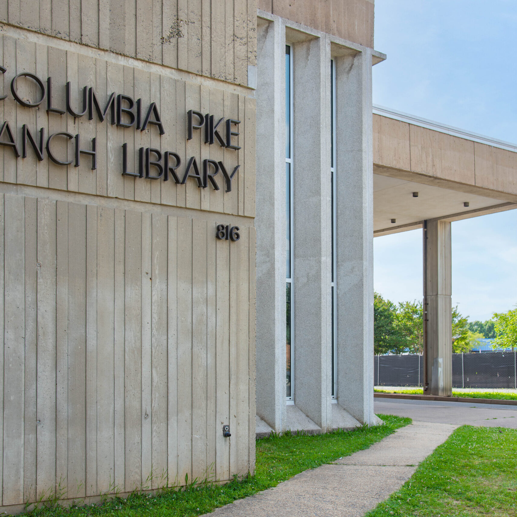 The outside of the Columbia Pike Branch Library building, with its name spelled in metal lettering on the exterior wall.