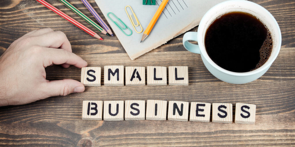 Small Business. Wooden letters on the office desk, informative and communication background