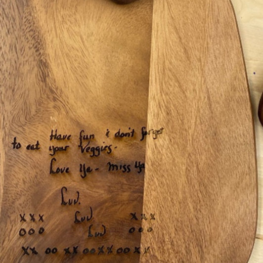 Photo of an engraved cheese wood cutting board.